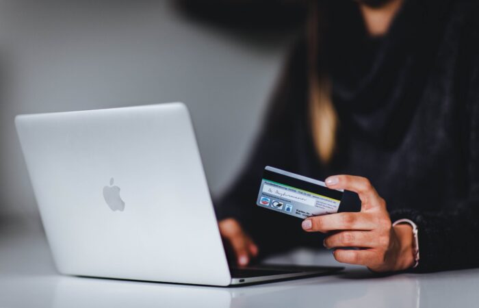 man using ecommerce website and holding credit card