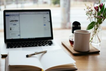 Article writing for beginners: Picture of a book, pen, and laptop.